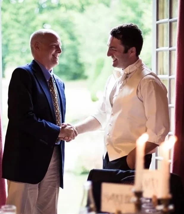 Mike Cobb shaking hands with a guest