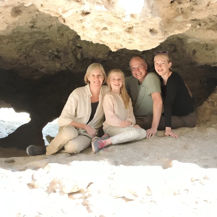 Mike Cobb with his family under a limestone overhang