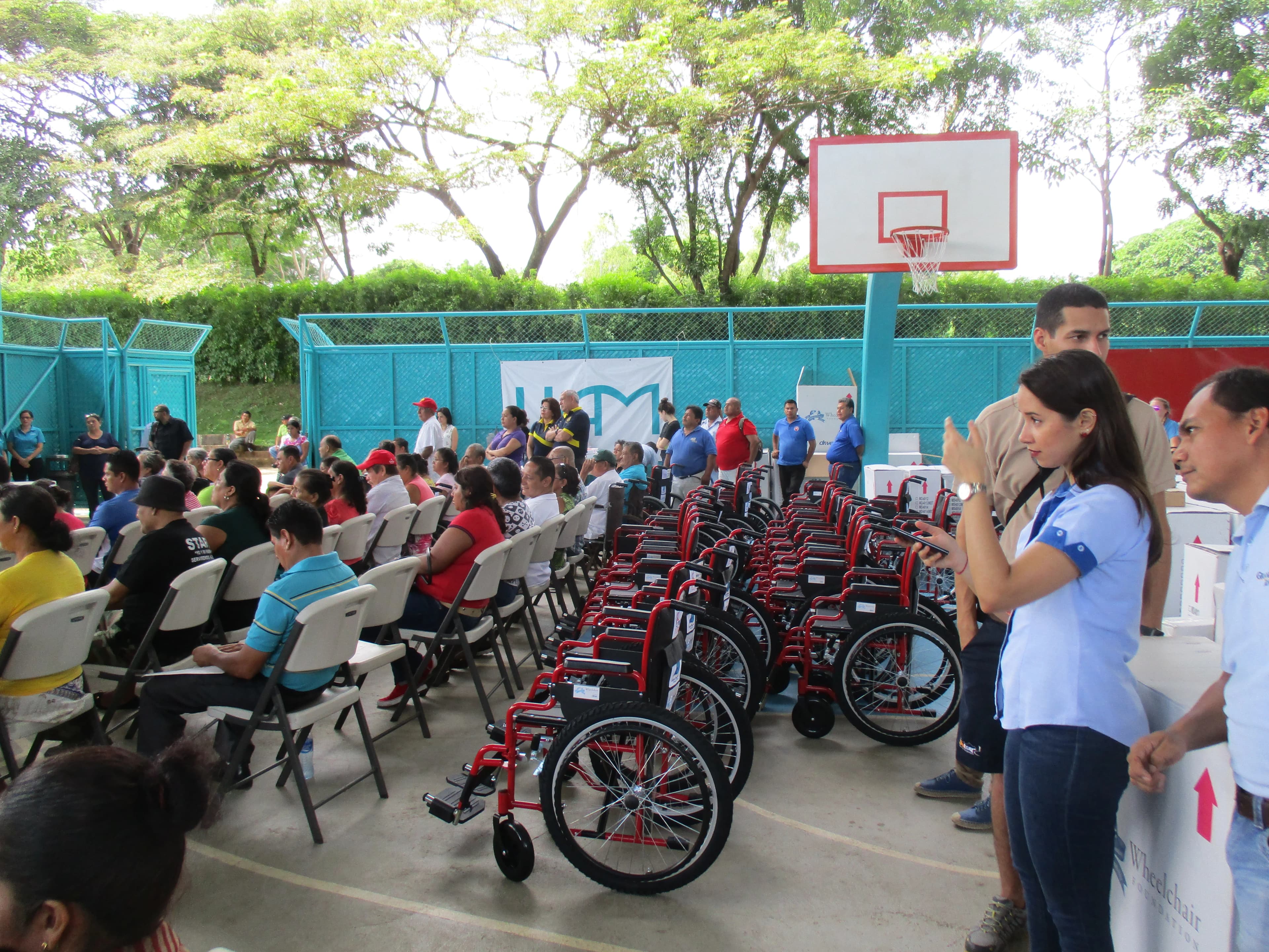 Rows of new wheelchairs lined up at a distribution event