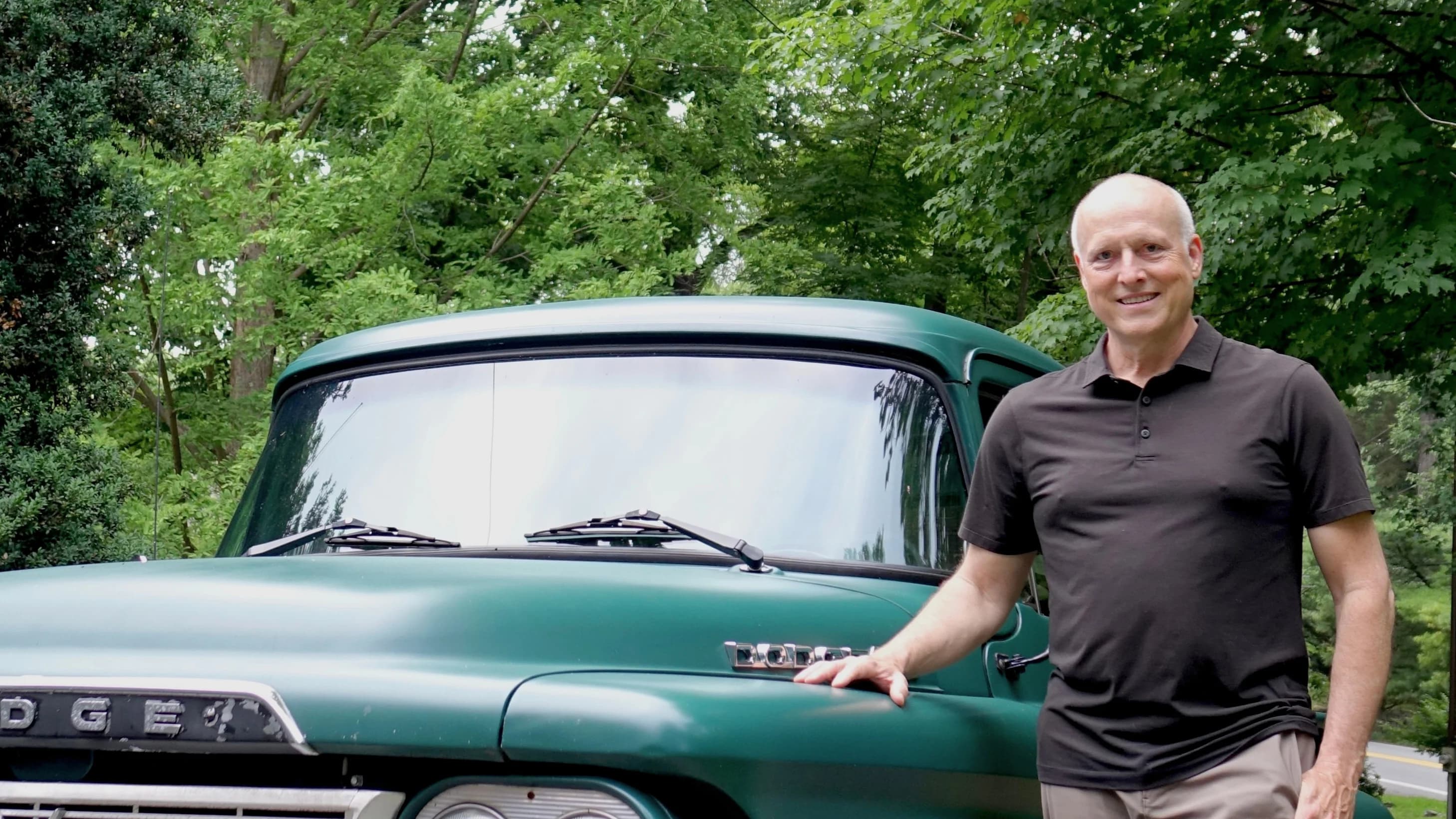 Mike Cobb standing beside a vintage green Dodge pickup